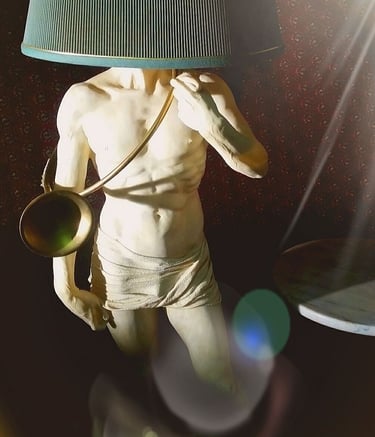 a statue of a man with a lamp on a table