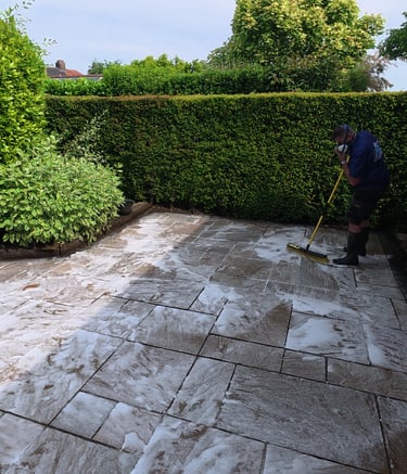 PJB Exterior Cleaning in Norwich, Norfolk applying chemical treatment and scrubbing Indian sandstone