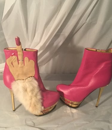 a pair of pink boots with a handmade finger - like finger - like finger