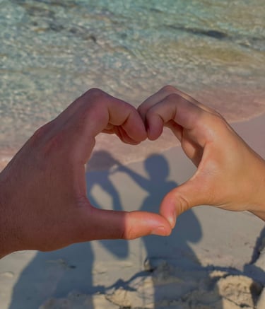 a person holding their hands in the shape of a heart
