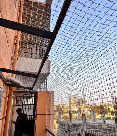 Wide shot of a residential building in Bengaluru fitted with safety nets on all balconies.