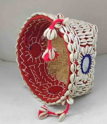 "Bamboo basket wrapped in red fabric with shell accents and floral garland–Designed for export