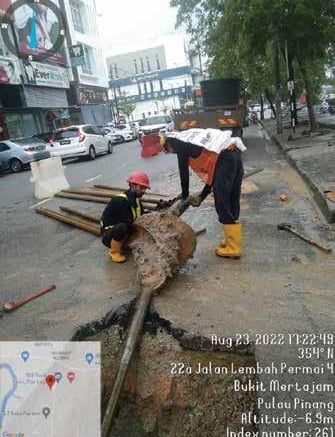 a man and woman working on a street