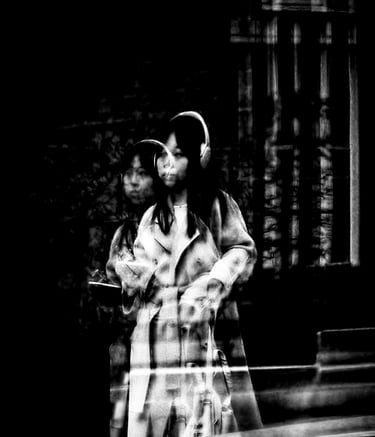 A woman doubly reflected in a window on Simpson Loan, Edinburgh