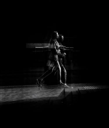 Two people walking, distorted through glass. The Usher Hall, Edinburgh