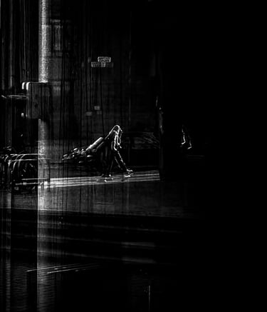 A man, with a ghost like shadow, taken through glass at The Usher Hall. Edinburgh