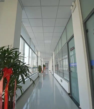 Zorulift Construction Machinery: Bright, modern office corridor to Manufacturing Dept. Clean, professional.