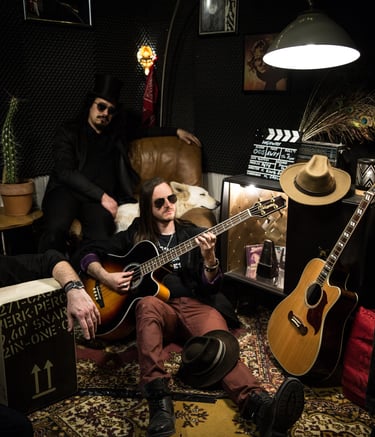 an hard rock band sitting around a guitar