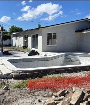 "General view of the backyard of a house with a pool under construction. 