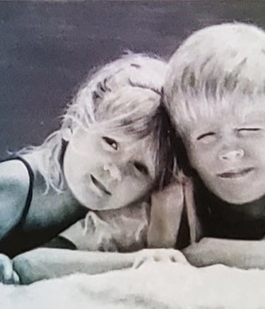 Siblings rendered in soft tones like a quiet chord of warmth and innocence