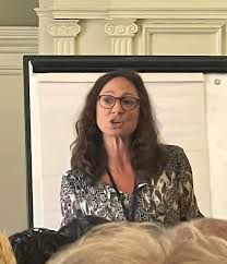 Kirsti giving a lecture at Oxford on psychology and spirituality, illustrating the academic foundation behind her work