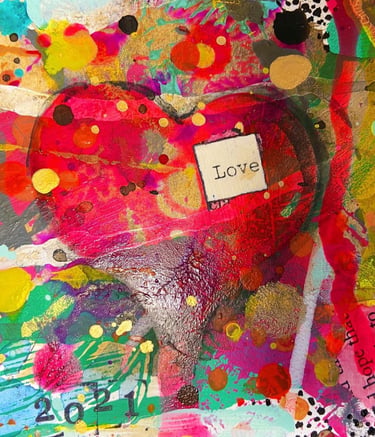 red paper mache heart with love 
