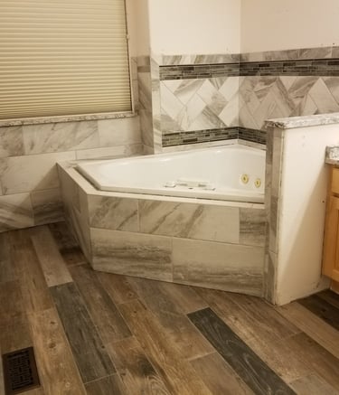 a bathroom with a tub tub and a shower