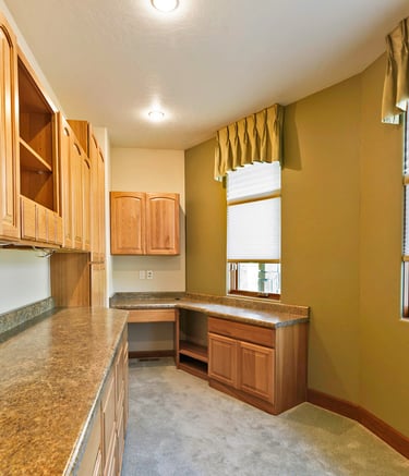 a office with a counter top and cabinets