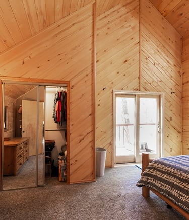 a bedroom with a bed and a bed in the corner