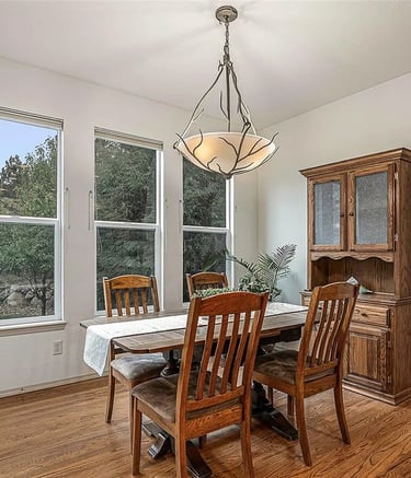 a dining room with a table and chairs