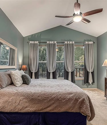 a bedroom with a ceiling fan and a ceiling fan
