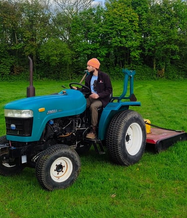 Compact tractor mowing