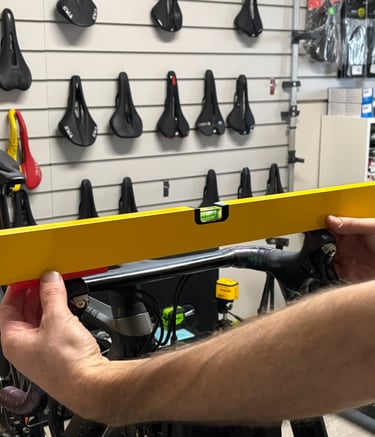 A bike fitter checking the handlebars are level