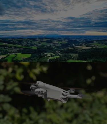 A compact camera drone flies over a scenic green valley under a cloudy sky.