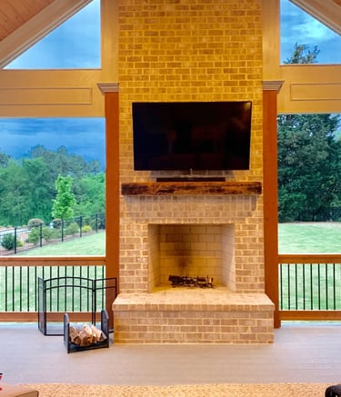 outdoor tv and soundbar mounted on a brick fireplace