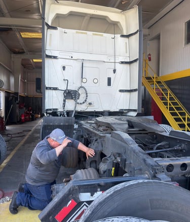 a man working on a truck in a garage