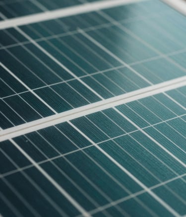 Close-up macro shot of high-efficiency monocrystalline solar cells, showing the intricate grid patterns and metallic textures. Professional lighting emphasizing deep teal and dark green surfaces with a clean, sharp focus.