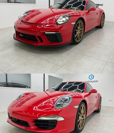 A vibrant red Porsche 911 luxury sports car with gold wheels parked in a modern showroom.