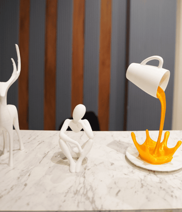 a person pouring orange juice into a cupcake