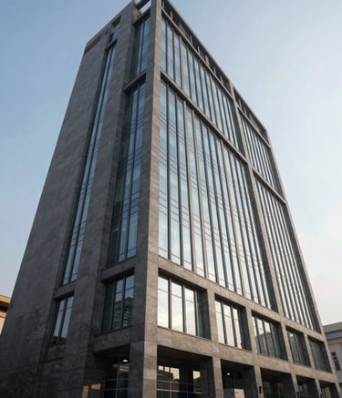 A wide-angle exterior shot of a contemporary corporate building in Pakistan. The facade features glass and disciplined slate grey steel. The image is captured in the early morning light, emphasizing clarity, trust, and sophisticated architecture.