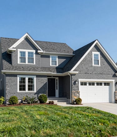 A wide-angle professional photograph of a beautiful suburban house in New Jersey featuring a newly installed dark gray shingle roof, set against a clear blue sky and a well-manicured green lawn, clean and modern aesthetic.
