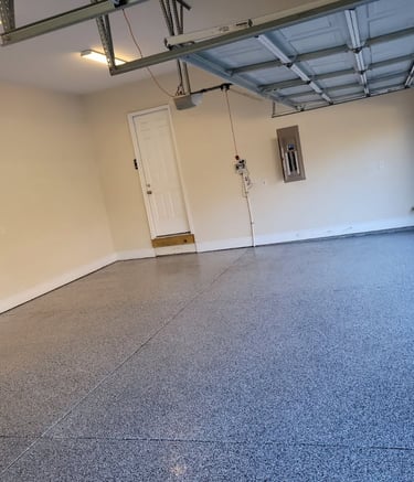 a garage with a garage door open and a garage door open