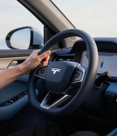 A close up of a modern car dashboard and steering wheel, professional driver's hands visible, soft morning light, interior accents in Deep Navy and Ocean Blue, high-tech and clean feel.