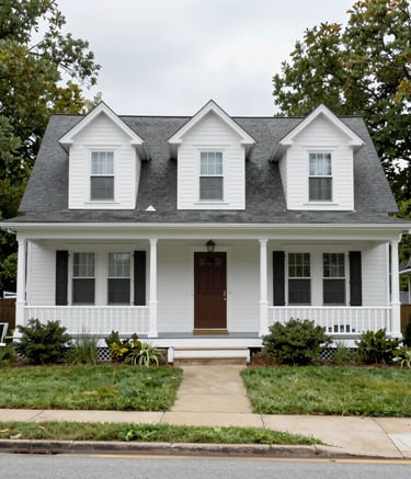 A crisp, professional wide-angle shot of a modern, multi-story residential building in a clean North American / US suburban neighborhood. The lighting is bright morning sun, highlighting the Sage Gray and Soft Off-White exterior textures against a clear sky.