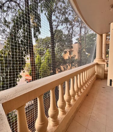 Close-up of a sturdy balcony pigeon net protecting a Bombay apartment.