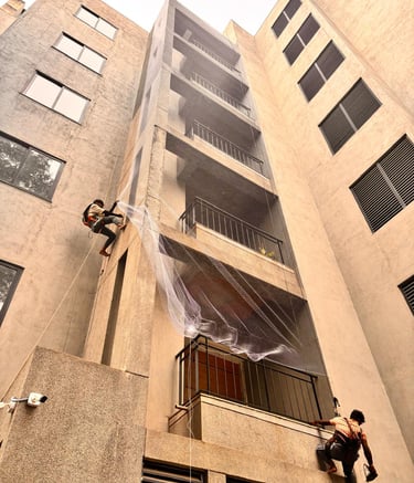 Wide shot of a high-rise building in Bombay fitted with pigeon safety nets.
