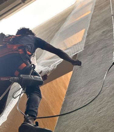 Technician carefully measuring balcony edges before net installation.