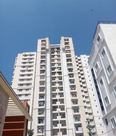 Wide shot showing multiple balconies fitted with safety nets in a Mumbai apartment.