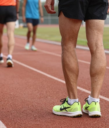 Volunteers handing out water to marathon runners.
