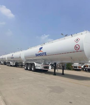 A row of white Dangote cement tanker trailers parked aftr production