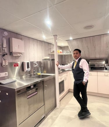 River crew standing in a modern stainless steel galley kitchen.