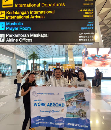 Crew holding AKA banner at an international airport 