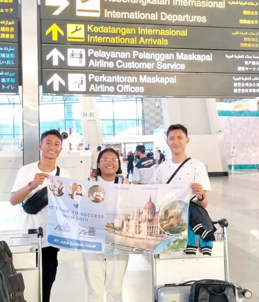 crew holding a AKA banner at an international airport 