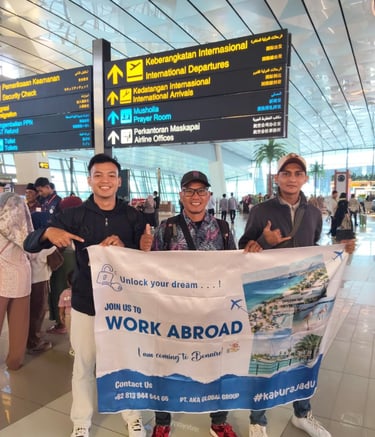 crew holding AKA banner at an international airport terminal.