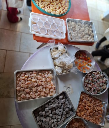 Assorted trays of colorful Turkish delight and traditional sweets on a display table.
