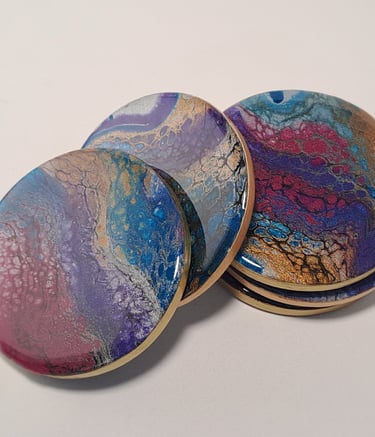 Handcrafted coasters, glossy resin art in swirling ocean blue, deep purple and gold cellular pattern