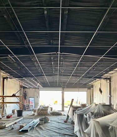 Structural ceiling grid installation for large-scale commercial lighting projects in Florida