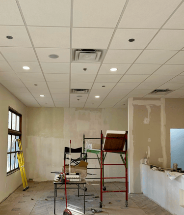 Completed acoustic ceilings with integrated recessed lighting and HVAC vents