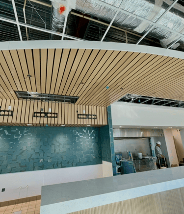 Luxury curved wood ceiling system and custom wood paneling installation in Florida
