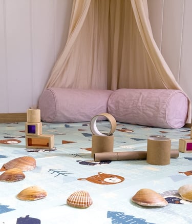 Racó de relax amb coixins i materials sensorials per a moments de calma i benestar dels infants.